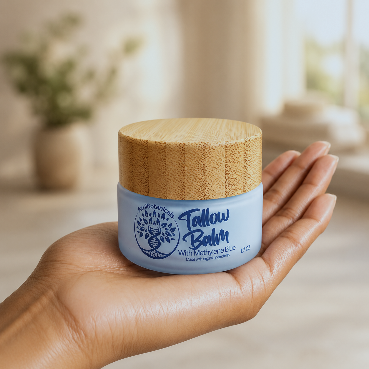 Hand holding a jar of Tallow Balm with a wooden lid in a blurred indoor setting