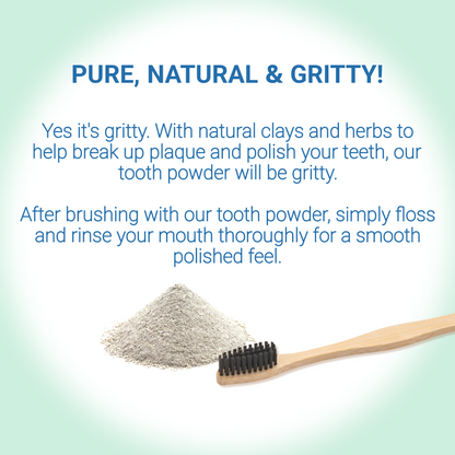 Bamboo toothbrush with tooth powder on a light green background